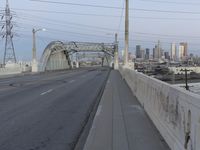 a city highway in the background with a tall white bridge that spans it's length