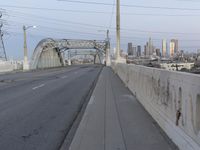 a city highway in the background with a tall white bridge that spans it's length