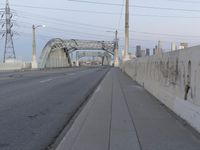 a city highway in the background with a tall white bridge that spans it's length