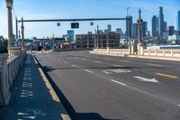 a picture of the city and an intersection on a busy city street, one way traffic signal with traffic in view