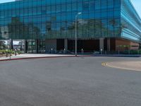 two grey blocks sitting next to a tall building on a sidewalk in front of grass