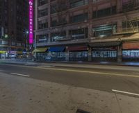 an empty city street at night lit with colorful signs and advertisements for the asian restaurant