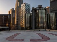 the top of the roof of the large skyscraper complex with the u written out in red on it