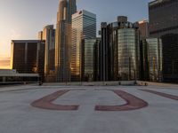 the top of the roof of the large skyscraper complex with the u written out in red on it