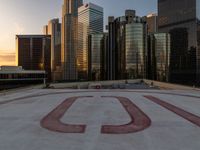 the top of the roof of the large skyscraper complex with the u written out in red on it