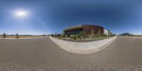 360 - angle photo of empty street with sun in the background and parking lot on both sides