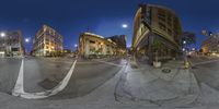 three identical view photos of an intersection at night with buildings in the distance and people walking on the street