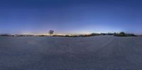 a wide angle shot looking down on the empty ground and city lights on in the distance