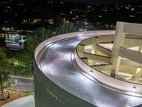 a view of a road and an overpass with traffic passing through it by buildings