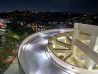 a view of a road and an overpass with traffic passing through it by buildings