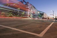 the building is decorated with some art and stripes, including stripes and shapes that give the appearance