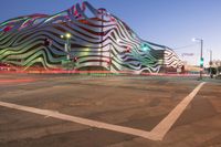 the building is decorated with some art and stripes, including stripes and shapes that give the appearance