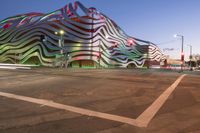 the building is decorated with some art and stripes, including stripes and shapes that give the appearance