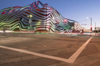 the building is decorated with some art and stripes, including stripes and shapes that give the appearance