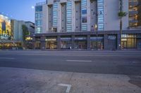 a store front with lots of windows on the sides of it in the city at night