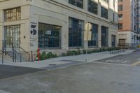 an empty street and some buildings next to each other, both in the same building