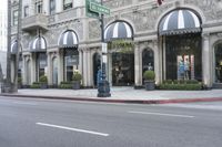 the street has several arched windows and a store front with awnings on it