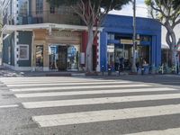 crosswalk on street in urban setting with pedestrian crossing in foreground and building at background