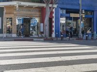 crosswalk on street in urban setting with pedestrian crossing in foreground and building at background