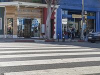 crosswalk on street in urban setting with pedestrian crossing in foreground and building at background