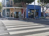 crosswalk on street in urban setting with pedestrian crossing in foreground and building at background