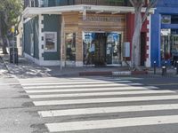 crosswalk on street in urban setting with pedestrian crossing in foreground and building at background