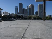 the city is in the background with other buildings in it by water with people walking on it