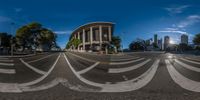 a large city street with buildings and white stripes on it is distorted to look like an opticalized photo