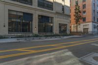 a red fire hydrant is sitting on the curb of a city street in front of a tall building