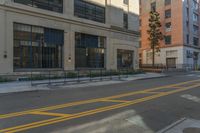 a red fire hydrant is sitting on the curb of a city street in front of a tall building