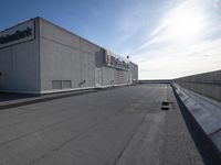 a black skateboarder riding on top of a flat roof in front of a cityscape