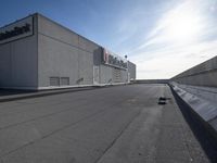 a black skateboarder riding on top of a flat roof in front of a cityscape