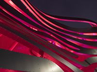 a night shot of the art installation at night with the full moon in the sky