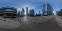 a fisheye lens view shows the intersection of an empty street in a big city