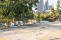 the street that has graffiti painted on it with trees in front of them and some skyscrapers