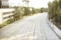 an overhead view looking down at a yellow line on a street in an empty city