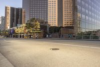 a road near tall buildings with a stop sign on the side of it that reads the corner