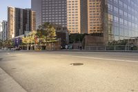 a road near tall buildings with a stop sign on the side of it that reads the corner