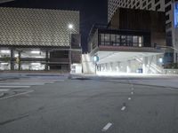 an empty street is lit with traffic lights, in the middle of the night,