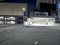 an empty street is lit with traffic lights, in the middle of the night,