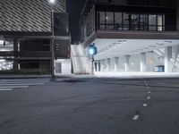 an empty street is lit with traffic lights, in the middle of the night,