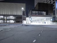 an empty street is lit with traffic lights, in the middle of the night,
