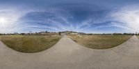 two fisheyes show the reflection of some buildings in this panorama lens photograph of a skateboarder at a park