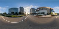 a distorted image of city buildings and road traffic seen through a fish eye lens lens