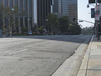 a person walking down a deserted city street with skyscrapers in the background in the daytime