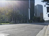 a person walking down a deserted city street with skyscrapers in the background in the daytime