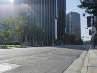 a person walking down a deserted city street with skyscrapers in the background in the daytime