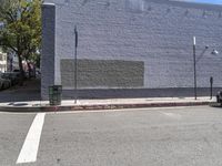 a building with a mural on it's side painted blue next to a curb