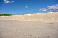 there is a white skateboard parked in a parking lot near the fenced area