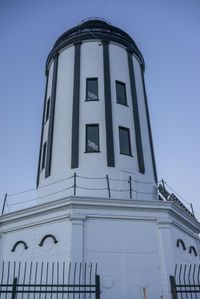 a lighthouse with windows on its roof is lit up by the sun and the sky